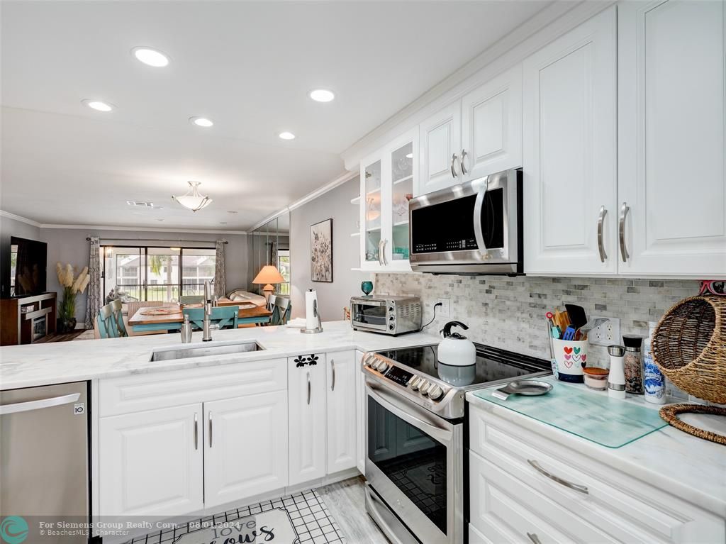 Gorgeous photo showing countertop, cabinets, kitchen appliances