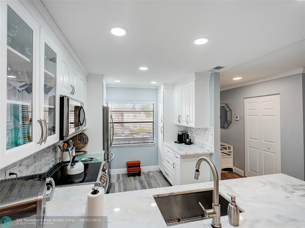 Gorgeous photo showing countertop, cabinets, kitchen appliances