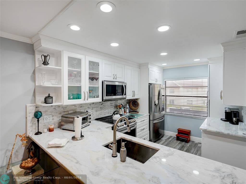 Gorgeous photo showing countertop, cabinets, kitchen appliances