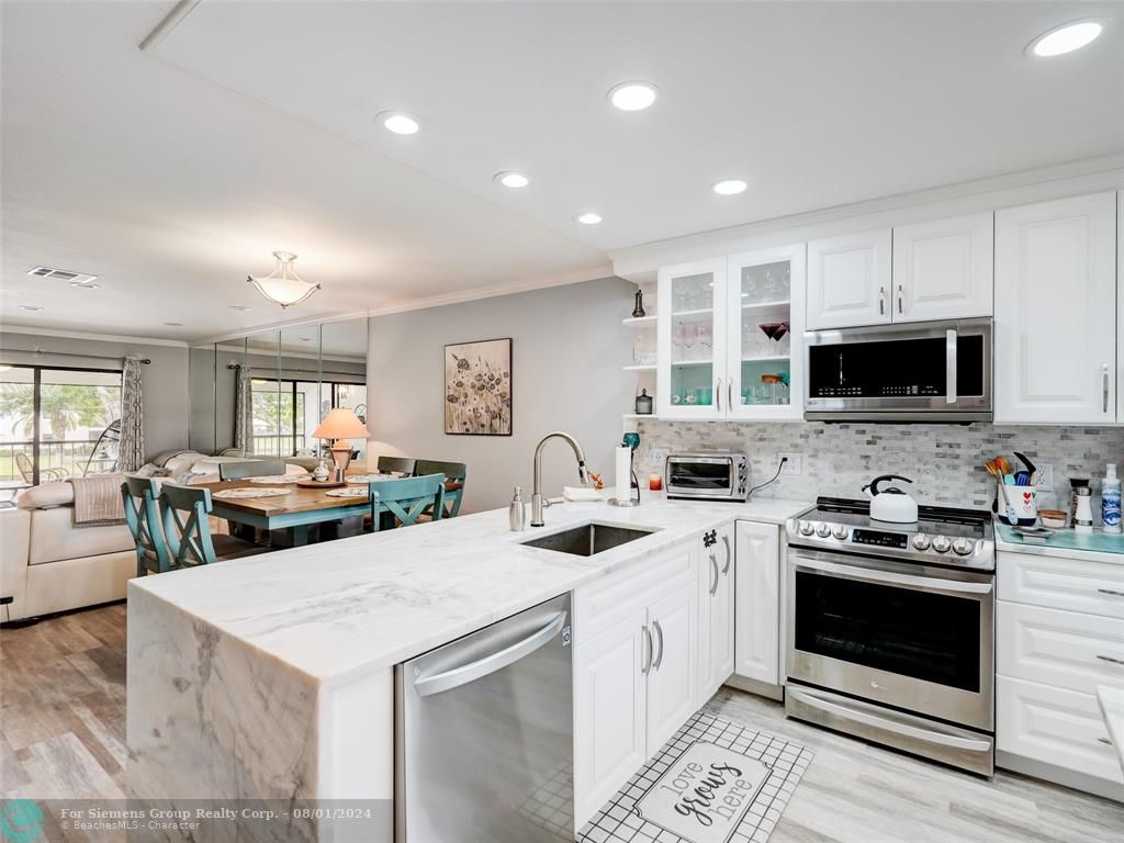 Gorgeous photo showing countertop, cabinets, kitchen appliances